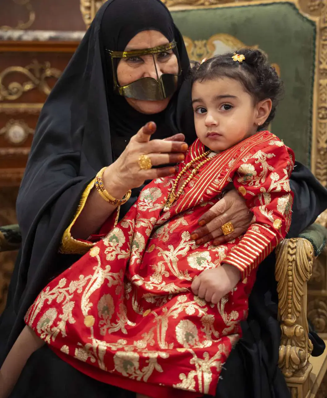 Amina holding her great-granddaughter